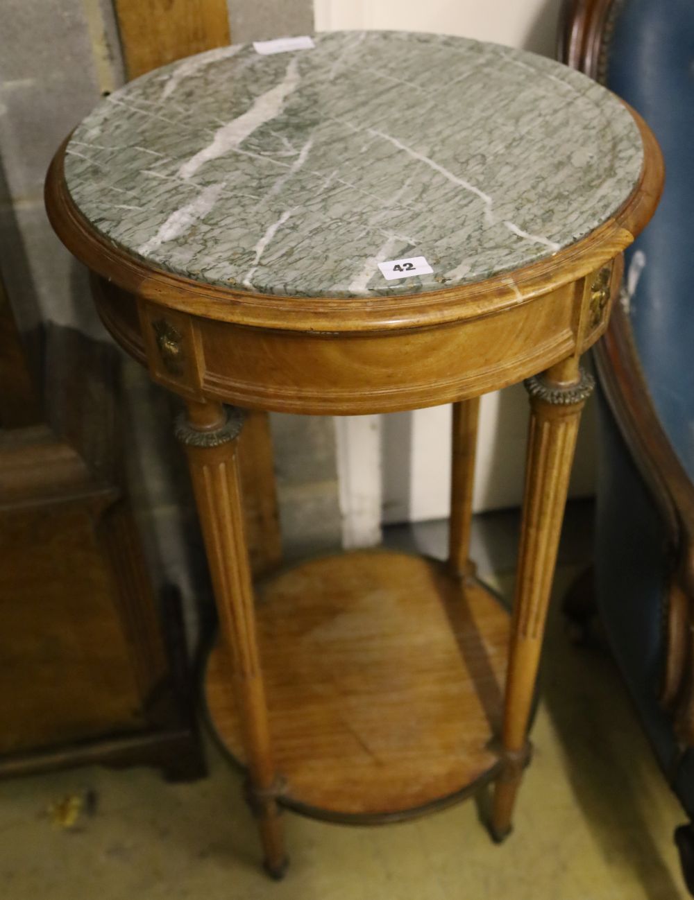 A Haentges Freres, Paris, circular marble top two tier table, diameter 47cm, height 84cm